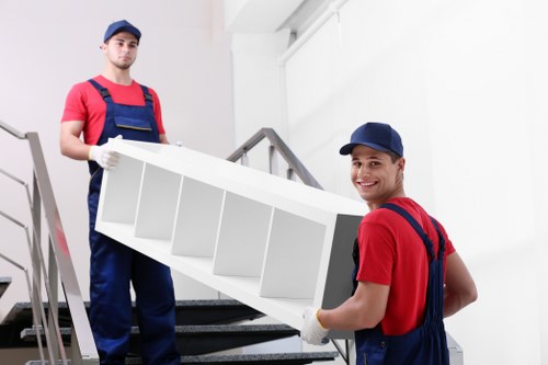 Professional movers handling boxed items during a van service