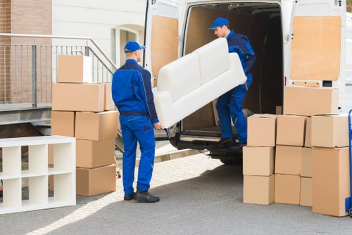 Removal van and movers on a residential street in Hackney