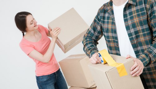 Furniture removals in Hackney with moving team handling a sofa