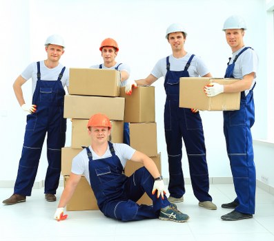 Removal team carrying furniture in a Hackney property